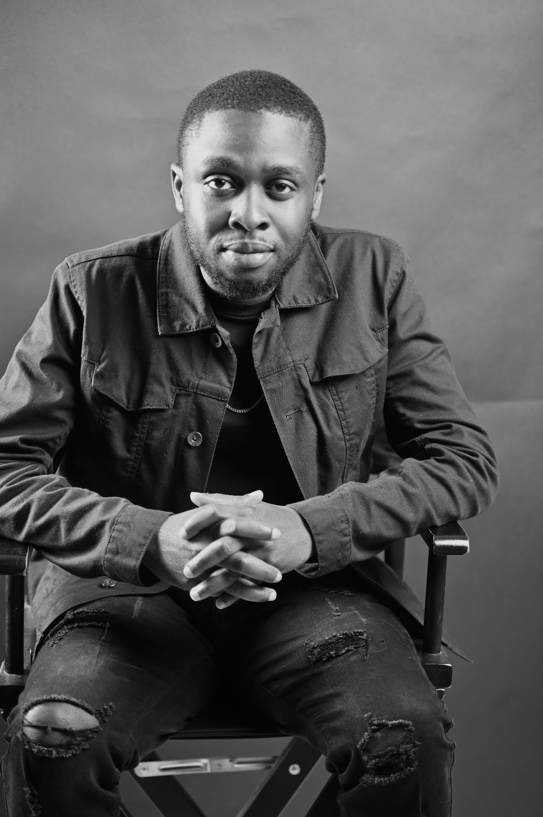Iretomide Jakim Ayo-Davidson seated for a portrait
